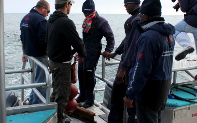 Dr Rhett Bennett deploying recievers with the Marine Dynamics crew